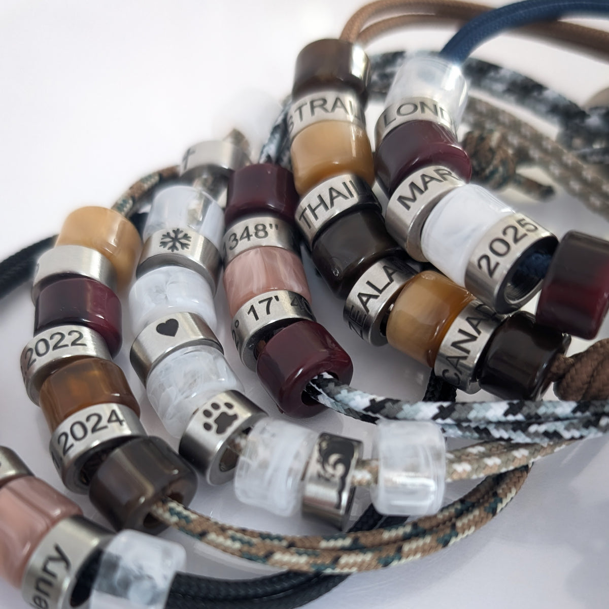 Personalised men’s cord bracelets with custom engraved beads, dates and symbols