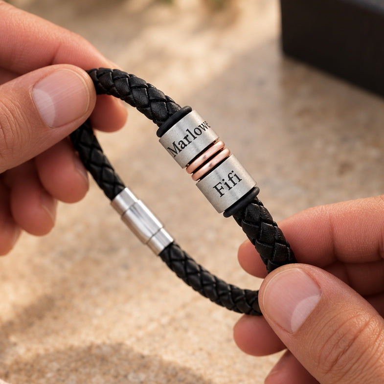 Personalised men's leather bracelet with silver engraved name rings and rose gold spacers