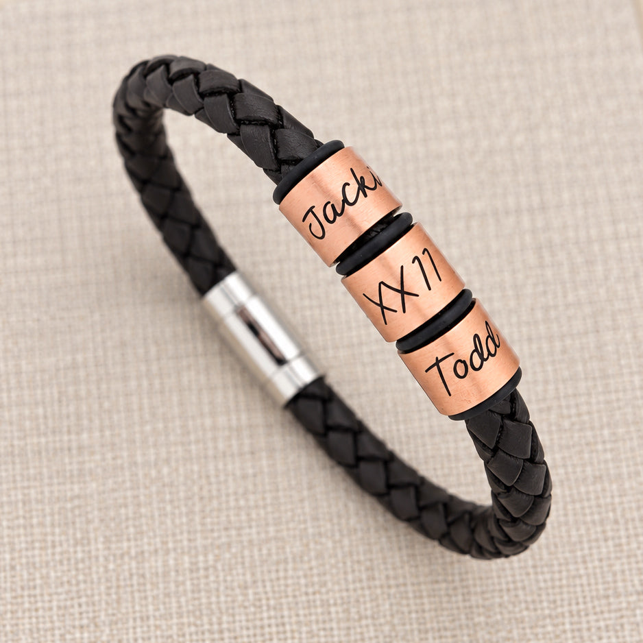 Personalised men's black leather bracelet with copper engraved name rings